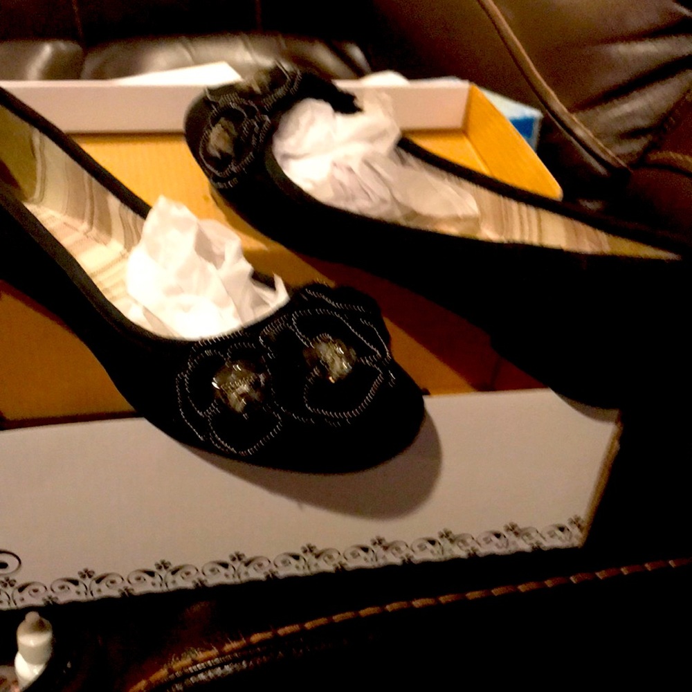 Black ballerina style slip on with crystal n flower on top. Worn once